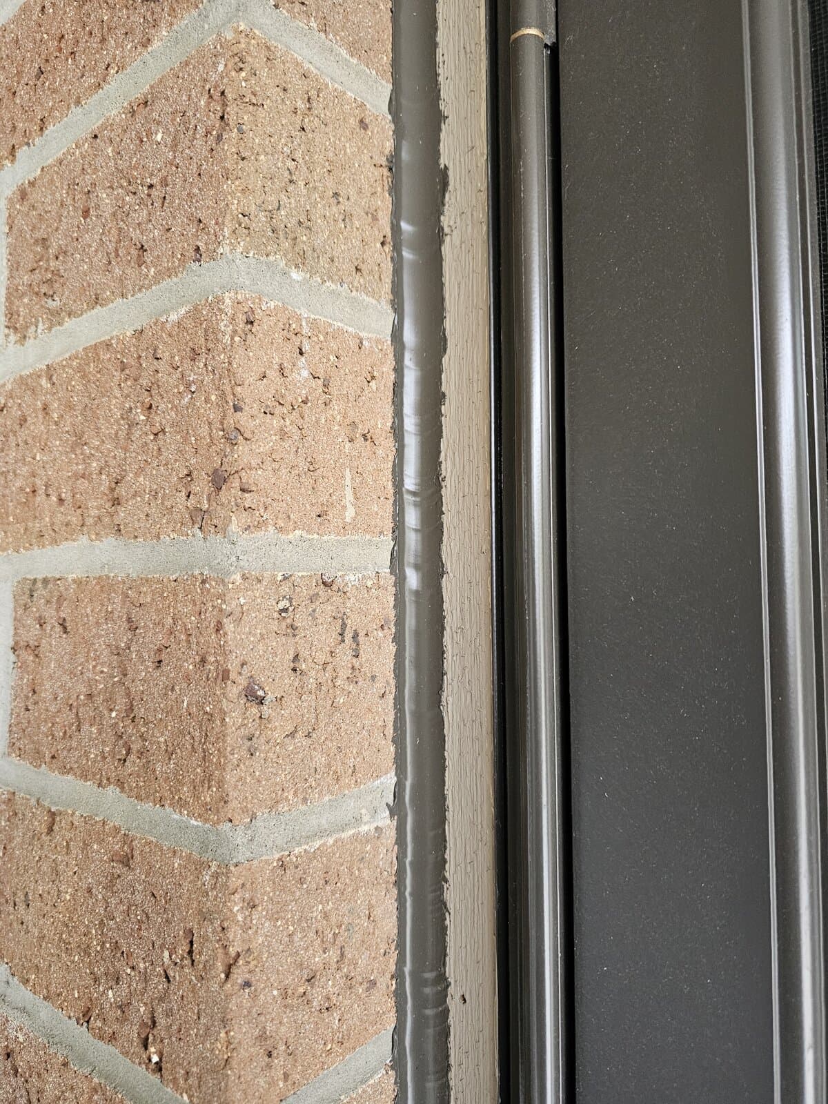 Close-up of brick wall with fresh tuckpointing mortar joints